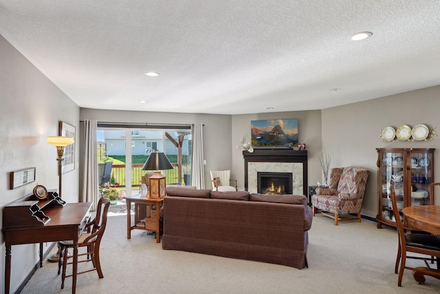 carpeted living room featuring a textured ceiling