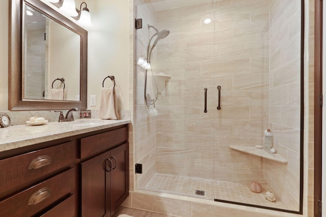 bathroom featuring vanity and an enclosed shower