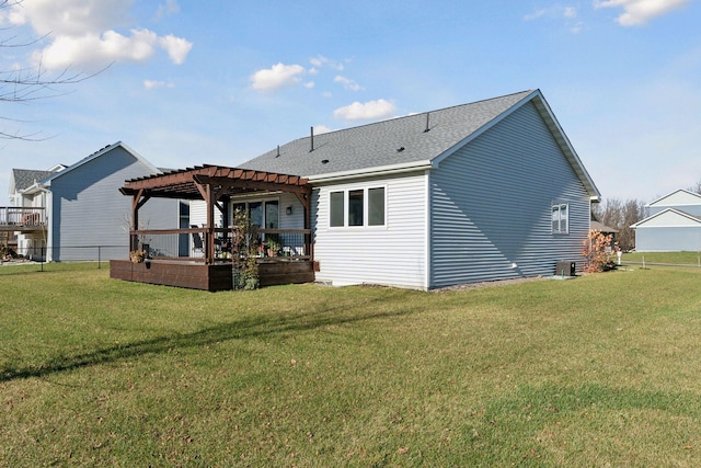 rear view of house featuring a pergola, a yard, and a deck