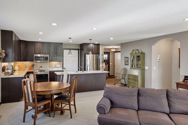 dining space with light colored carpet and sink