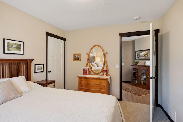 carpeted bedroom with a textured ceiling