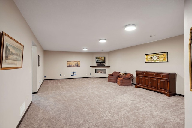 sitting room featuring light carpet