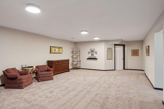 sitting room featuring light colored carpet