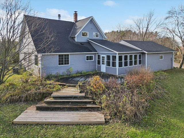 rear view of house featuring a deck and a sunroom