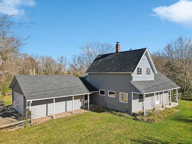 rear view of property with covered porch and a yard