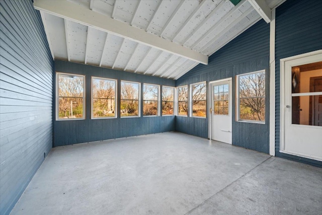 unfurnished sunroom with lofted ceiling with beams