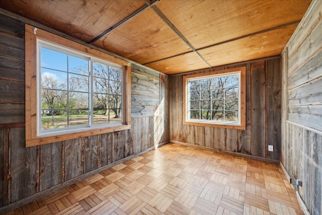 unfurnished sunroom with wooden ceiling