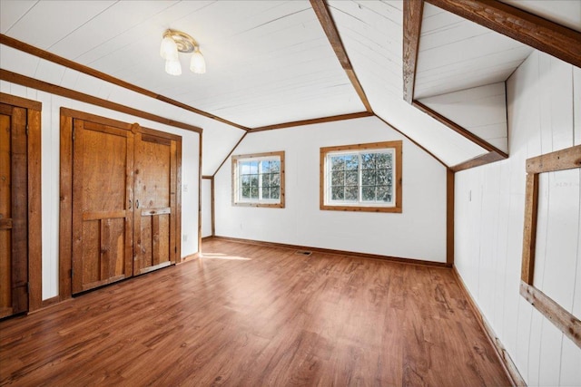 bonus room with vaulted ceiling and hardwood / wood-style flooring