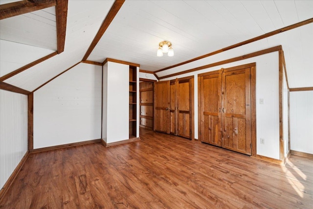 bonus room featuring lofted ceiling and wood-type flooring