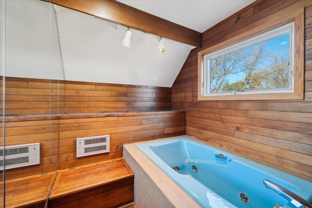 bathroom featuring tiled bath, vaulted ceiling, a wall unit AC, and wood walls