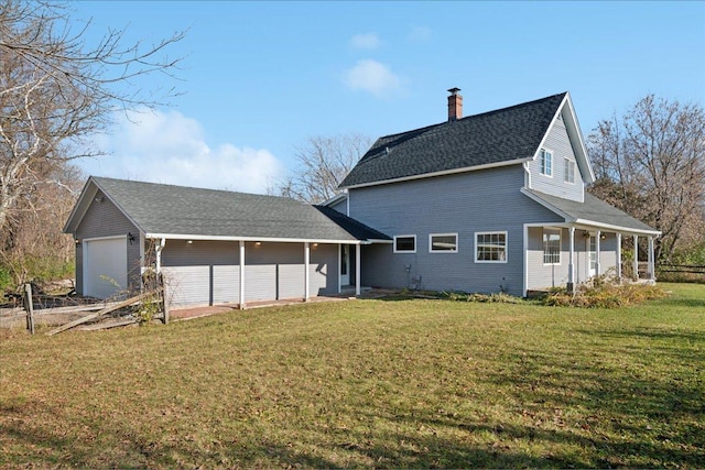 exterior space featuring covered porch, a yard, and a garage