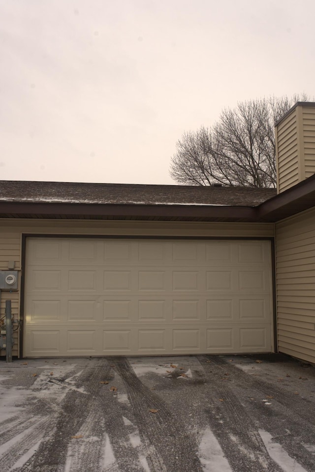 view of garage at dusk