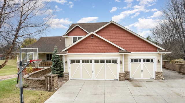 24850 Edenvale Trl, Elko New Market, MN 55020 - view of front of house with driveway, stone siding, and a garage