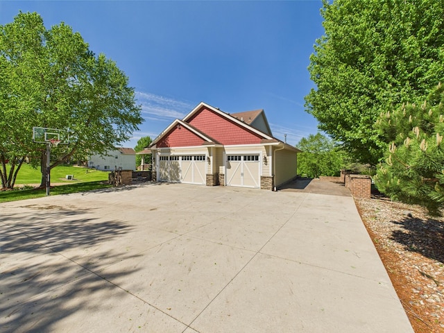 24850 Edenvale Trl, Elko New Market, MN 55020 - view of side of home with stone siding, driveway, and an attached garage