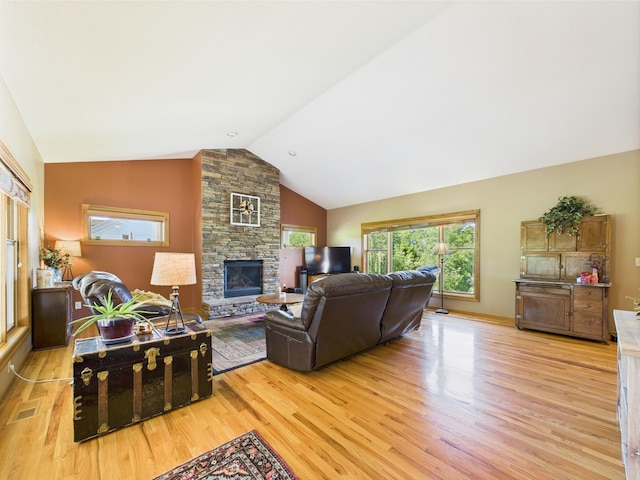 24850 Edenvale Trl, Elko New Market, MN 55020 - living area with light wood-type flooring, lofted ceiling, and a fireplace