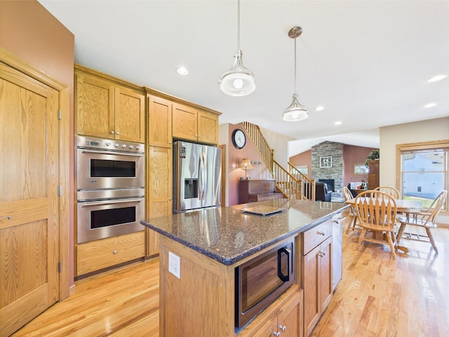 24850 Edenvale Trl, Elko New Market, MN 55020 - kitchen with stainless steel appliances, light wood-style flooring, a center island, recessed lighting, and dark stone counters