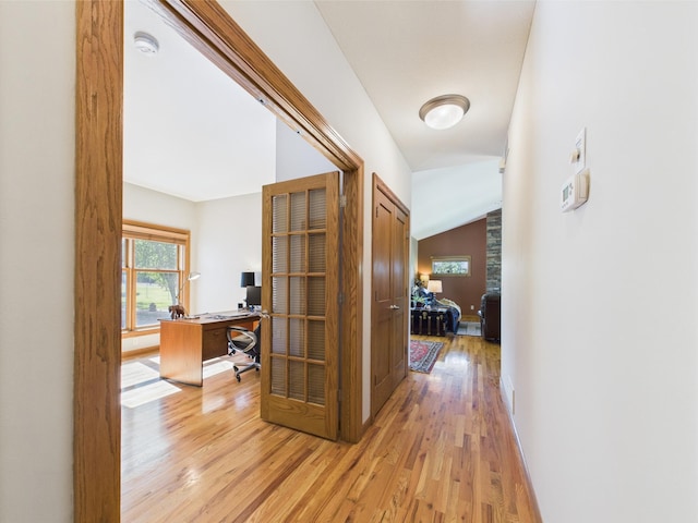 24850 Edenvale Trl, Elko New Market, MN 55020 - hallway with light wood-style floors, healthy amount of natural light, an office area, and lofted ceiling