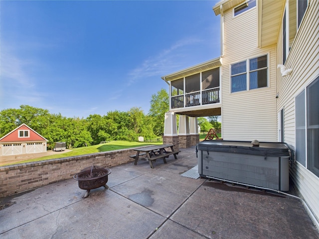 24850 Edenvale Trl, Elko New Market, MN 55020 - view of patio with a hot tub, a fire pit, and a sunroom
