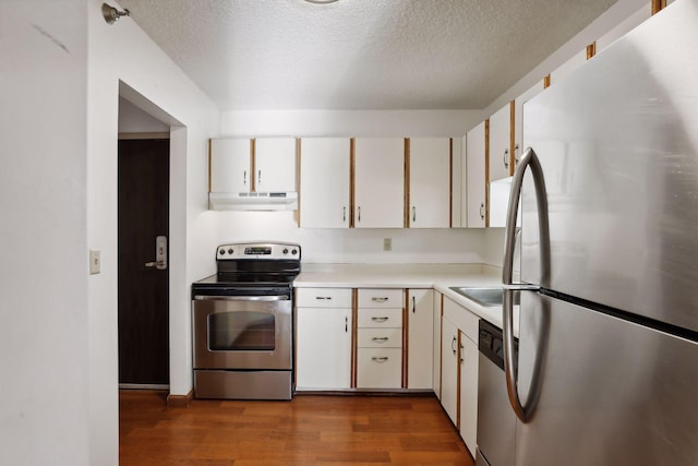 kitchen featuring white cabinetry, appliances with stainless steel finishes, a textured ceiling, and dark hardwood / wood-style flooring