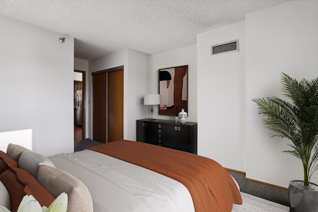 bedroom with a closet and a textured ceiling