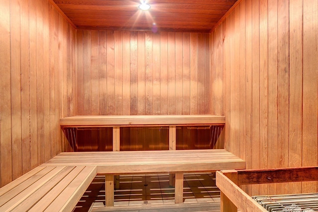 view of sauna featuring wooden walls and wood ceiling