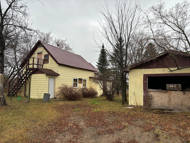 view of side of property with a garage and an outdoor structure