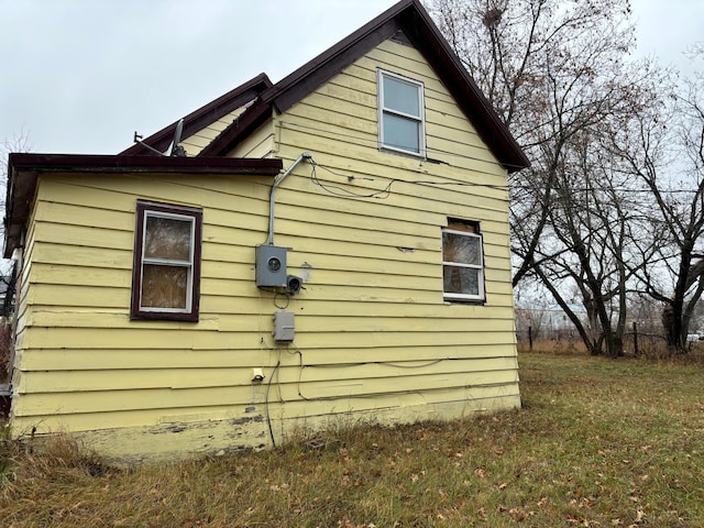 view of side of property with a yard