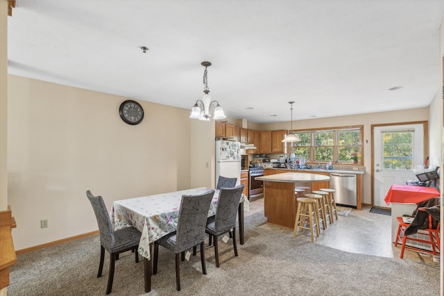 carpeted dining space featuring an inviting chandelier