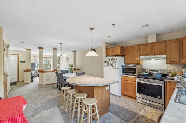 kitchen with a breakfast bar, stainless steel appliances, light colored carpet, pendant lighting, and a kitchen island