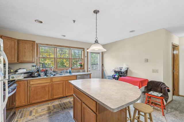 kitchen featuring pendant lighting, a center island, stainless steel appliances, and dark colored carpet