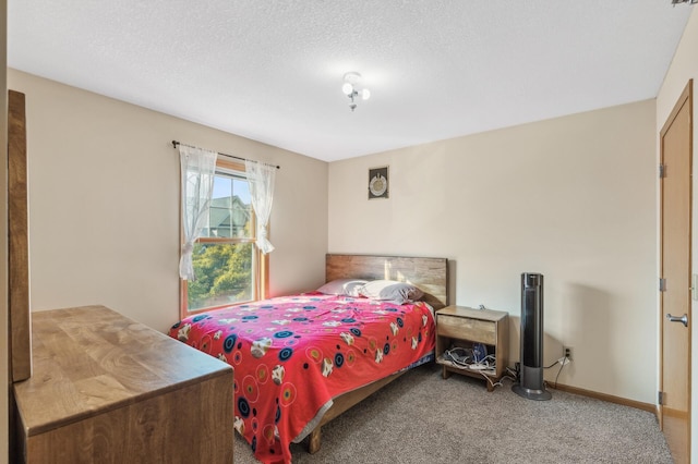 carpeted bedroom featuring a textured ceiling