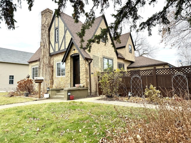 tudor home featuring a front lawn