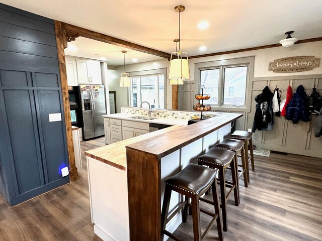 820 Labree Ave N, Thief River Falls, MN 56701 - kitchen with stainless steel fridge, wooden counters, a sink, dark wood finished floors, and white cabinetry