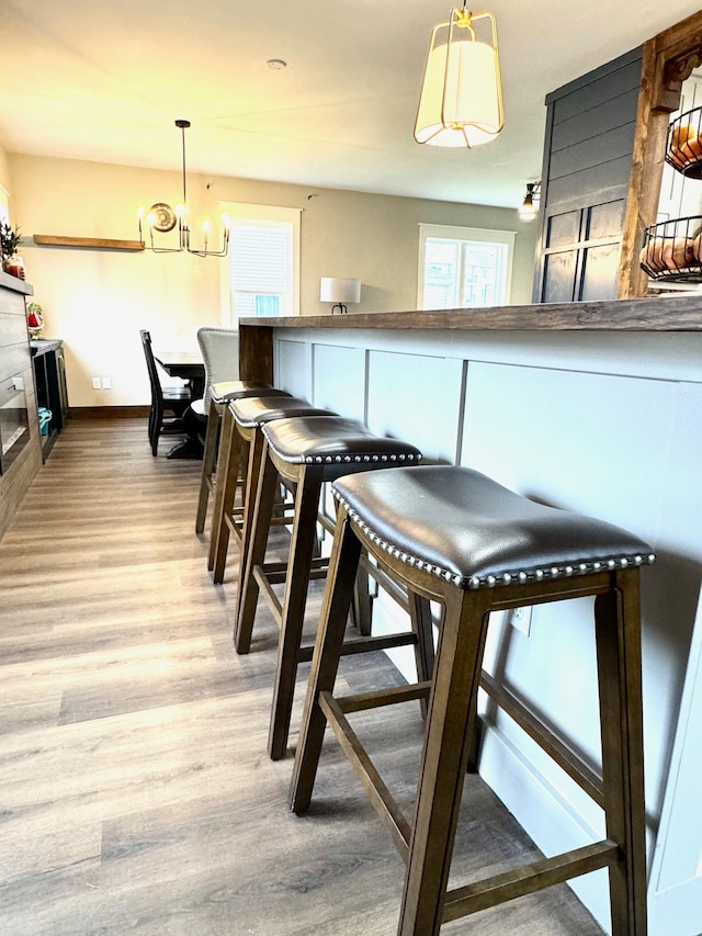 820 Labree Ave N, Thief River Falls, MN 56701 - dining room with light wood-type flooring, baseboards, and a chandelier