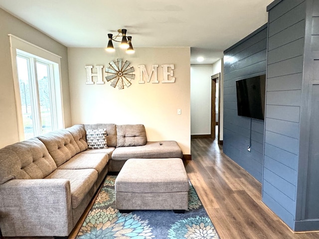 living room featuring a large fireplace and dark hardwood / wood-style floors