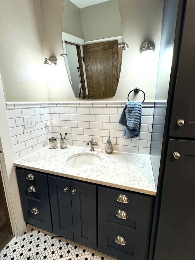 820 Labree Ave N, Thief River Falls, MN 56701 - bathroom featuring vanity, backsplash, and tile patterned floors