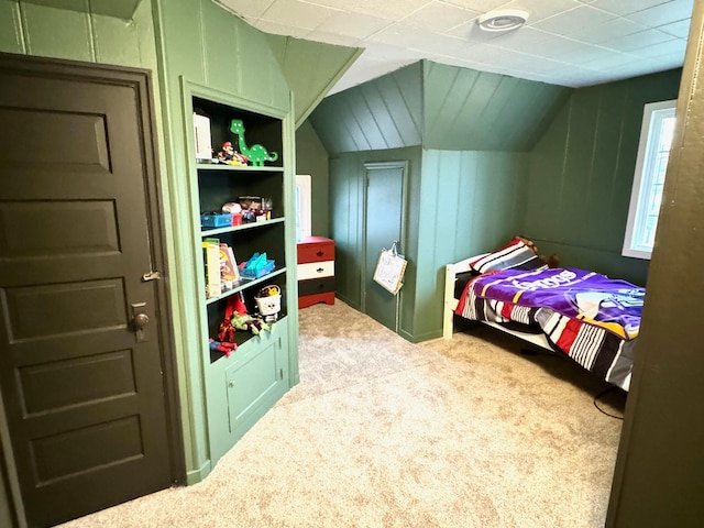 bedroom with carpet flooring and lofted ceiling