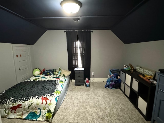 carpeted bedroom with lofted ceiling