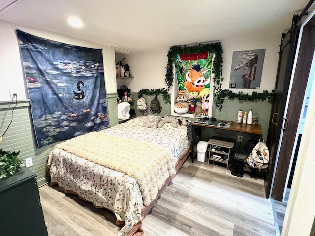 820 Labree Ave N, Thief River Falls, MN 56701 - bedroom featuring wood finished floors, a barn door, and recessed lighting