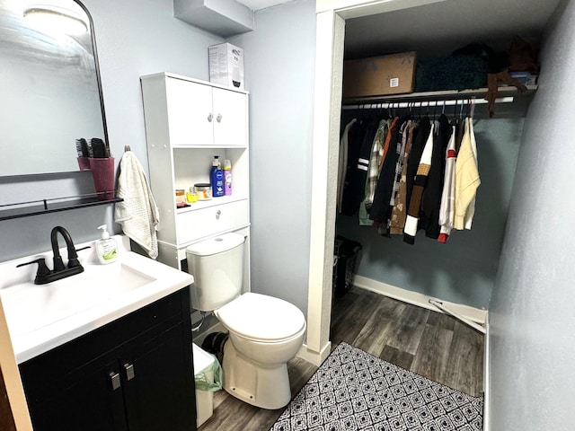 bathroom featuring hardwood / wood-style floors, vanity, and toilet