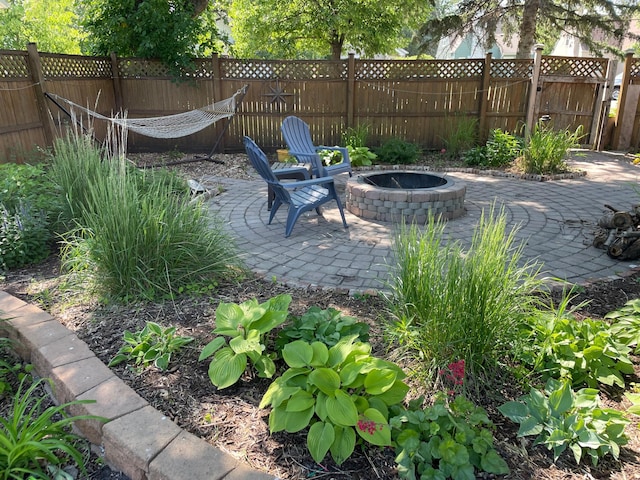 view of patio / terrace featuring an outdoor fire pit