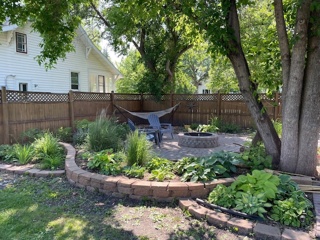 view of yard featuring an outdoor fire pit and a patio area