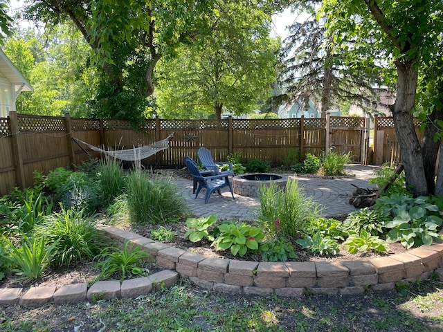 view of yard with a fire pit and a patio area