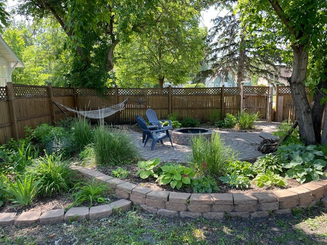 820 Labree Ave N, Thief River Falls, MN 56701 - fenced backyard with a fire pit and a patio area