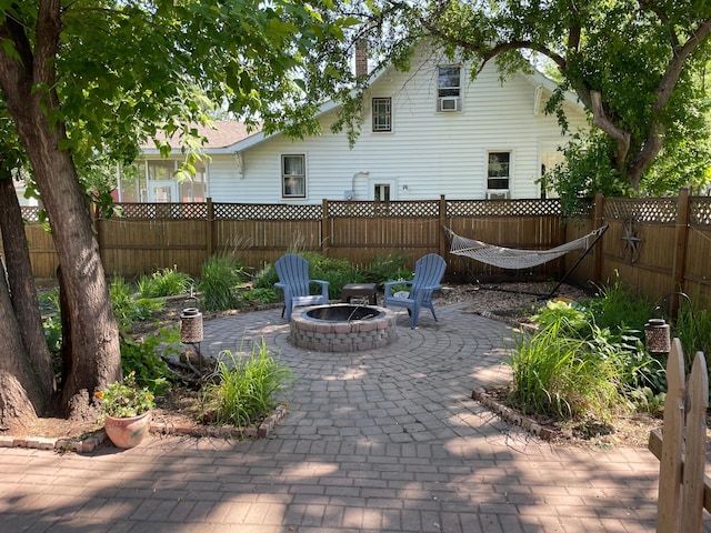 820 Labree Ave N, Thief River Falls, MN 56701 - fenced backyard featuring a patio area and a fire pit