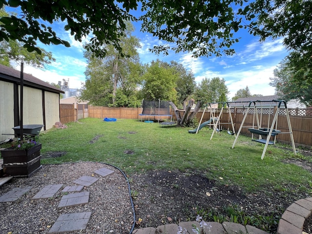 view of yard featuring a playground and a trampoline