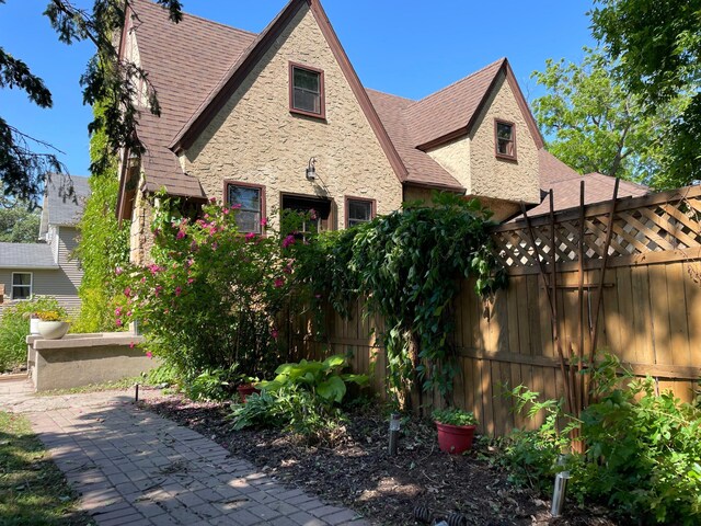 820 Labree Ave N, Thief River Falls, MN 56701 - view of front of house with roof with shingles and stone siding