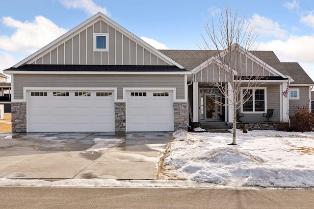 craftsman house featuring board and batten siding, concrete driveway, stone siding, and a garage