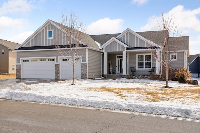 view of front of property featuring stone siding, board and batten siding, and roof with shingles