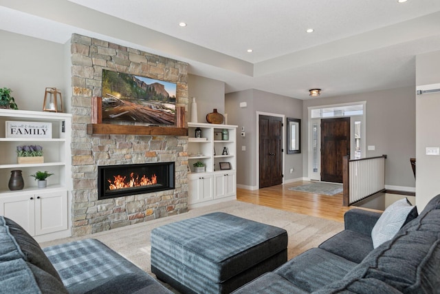 12770 196th Ave NW, Elk River, MN 55330 - living room featuring light wood finished floors, a fireplace, recessed lighting, and baseboards